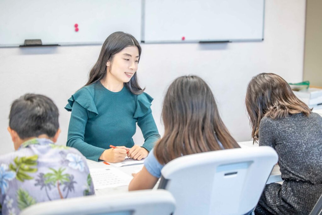 Children studying with teacher in a Japanese group class
